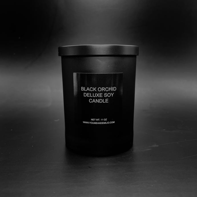 Black Orchid Deluxe Soy Candle in a sleek black jar, glowing warmly with an elegant and luxurious ambiance.