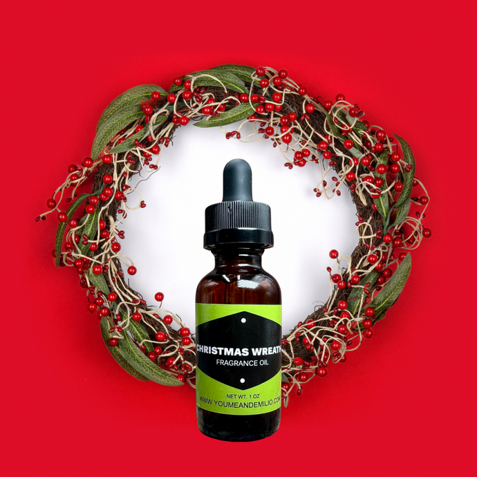 A festive bottle of Christmas Wreath Fragrance Oil, featuring a warm blend of pine, cedar, and holiday spices, perfect for creating a cozy seasonal ambiance.