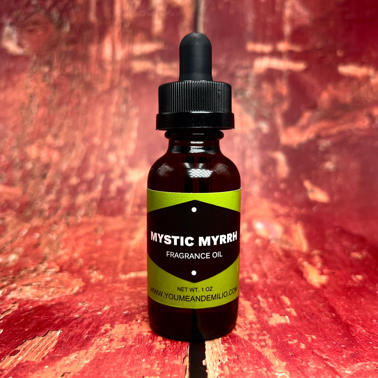 A sleek amber glass bottle of Mystic Myrrh Fragrance Oil with a black dropper cap, exuding an aura of mysticism and deep, earthy notes.